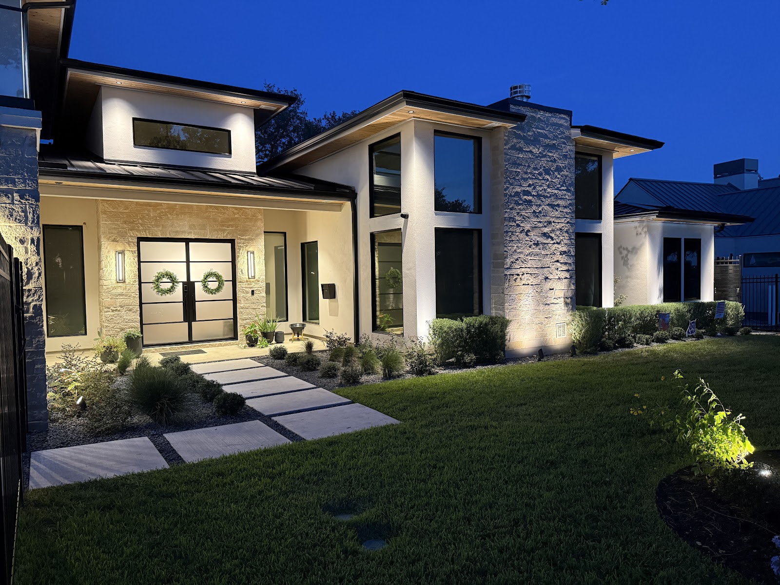 Manuel Residence front elevation at dusk, architectural and landscape lighting
